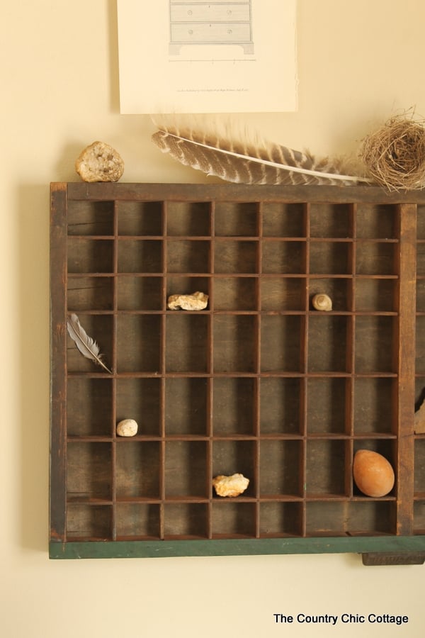 A close-up of things inside a printer's tray in farmhouse style mudroom.
