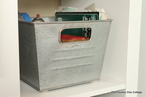 Galvanized metal bins holding tools and books 