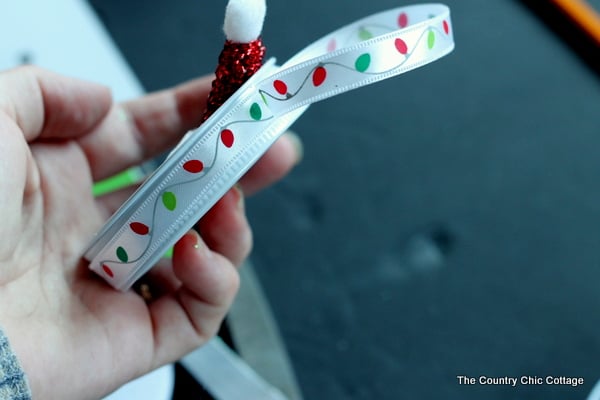 adding ribbon hanger to a christmas ornament