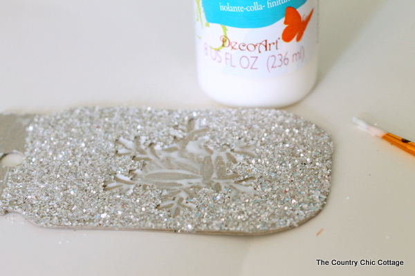 Make these glittered mason jar ornaments easily with a Cricut Explore. Click here to learn how!