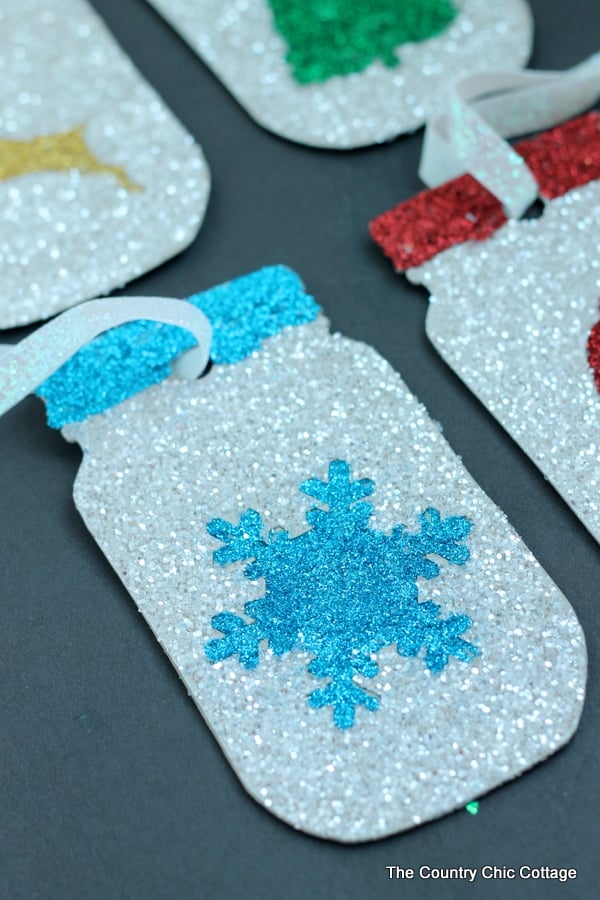 Make these glittered mason jar ornaments easily with a Cricut Explore. Click here to learn how!