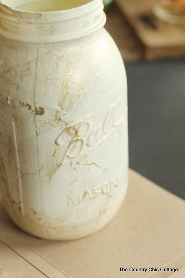 white mason jar marbled in gold spray paint