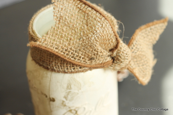 burlap ribbon tied around gold marbled mason jar