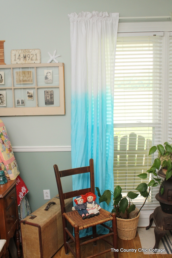 Dip dyed curtains hanging in bedroom 