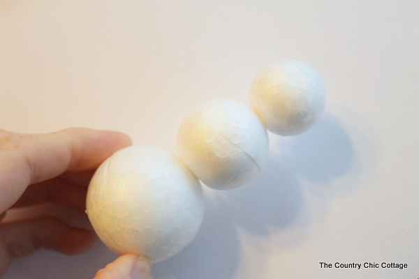 piecing foam balls together to make a snowman