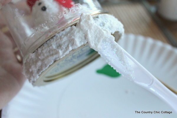 painting fake snow on the jar