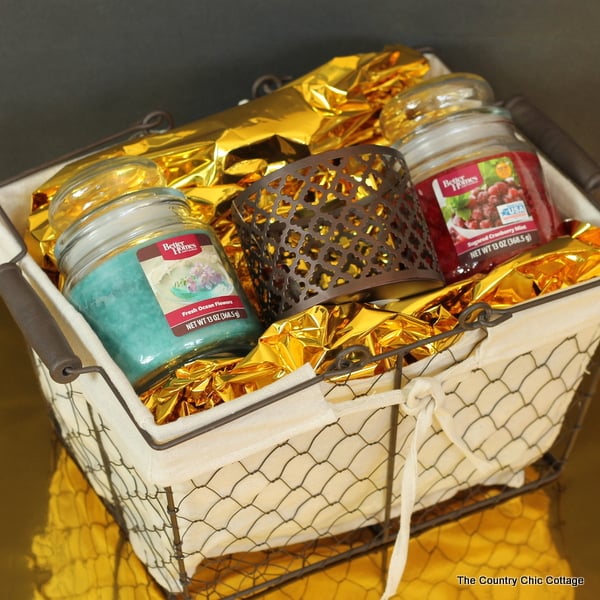 Use some gold foil gift wrap to add a sparkling touch to this candle lovers gift basket