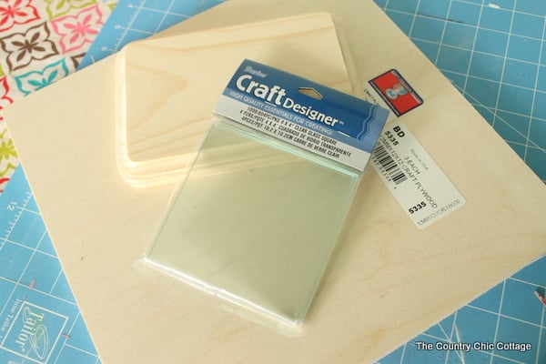 Craft Designer tile and wooden pieces on blue measuring craft mat