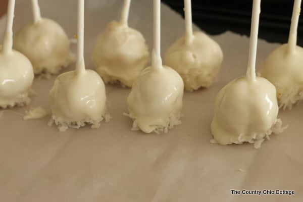 wet cake pops drying on parchment paper