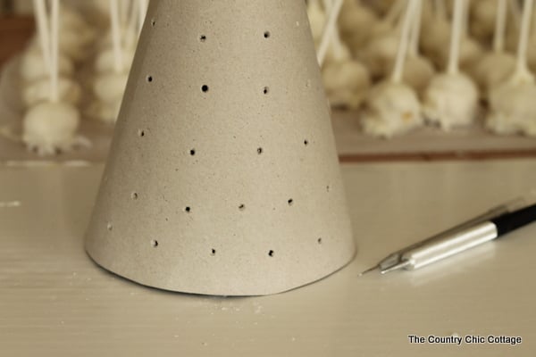 close up of chipboard cone with holes punched in it