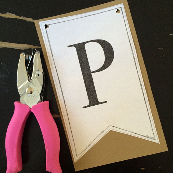 hole punch and letter "P" in black ink on white cardstock