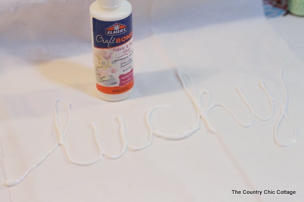 hand drawing word on canvas with glue 
