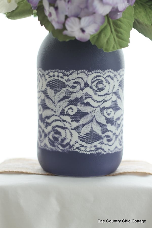 Lace Mason Jar Vase -- use two paint colors and lace as a mask to create this gorgeous painted vase for your wedding, home, or any party. Get the full step by step instructions here. Can you believe this is just paint? There is no actual lace on this jar!