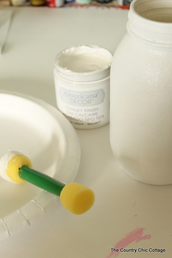 white painted mason jar and poucer brush