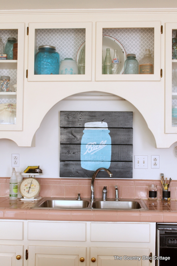 mason jar pallet art hanging above kitchen sink