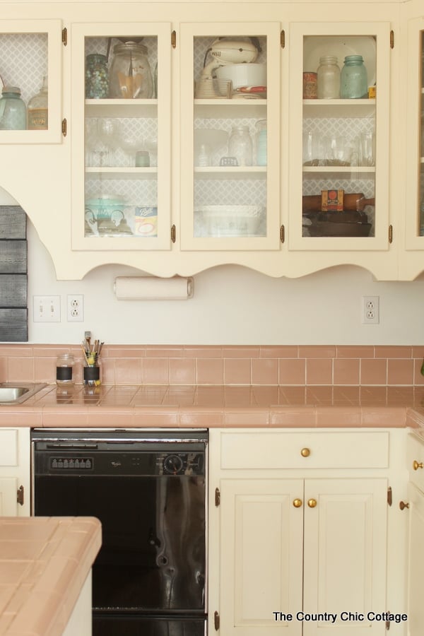 touring a farmhouse rustic kitchen: glass cabinets with jars inside