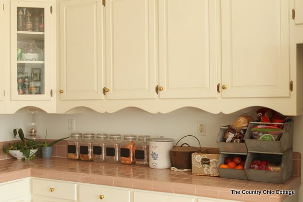 Rustic farmhouse kitchen tour: food baskets and canisters on the counter.