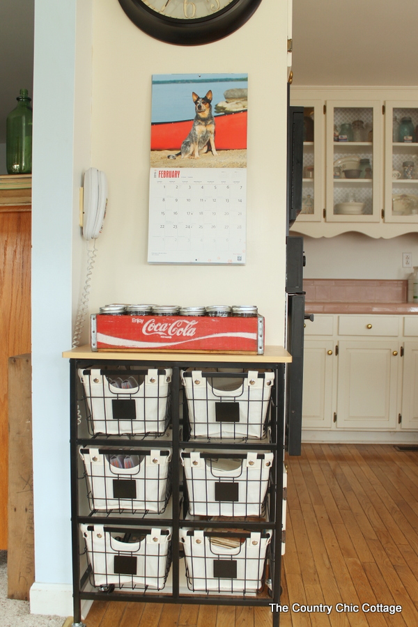 rustic roll away cart with canvas and iron baskets.