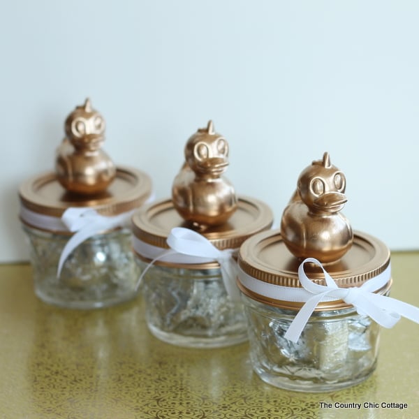 mason jars with rubber ducks attached to top