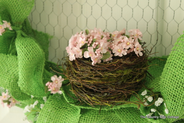filling the nest with flowers for the Spring Burlap Wreath 