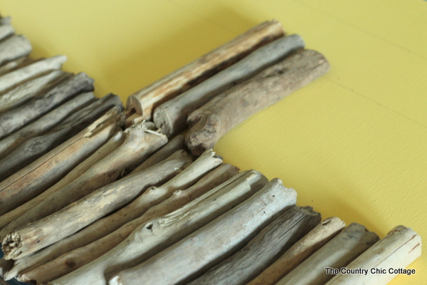 arranging driftwood pieces