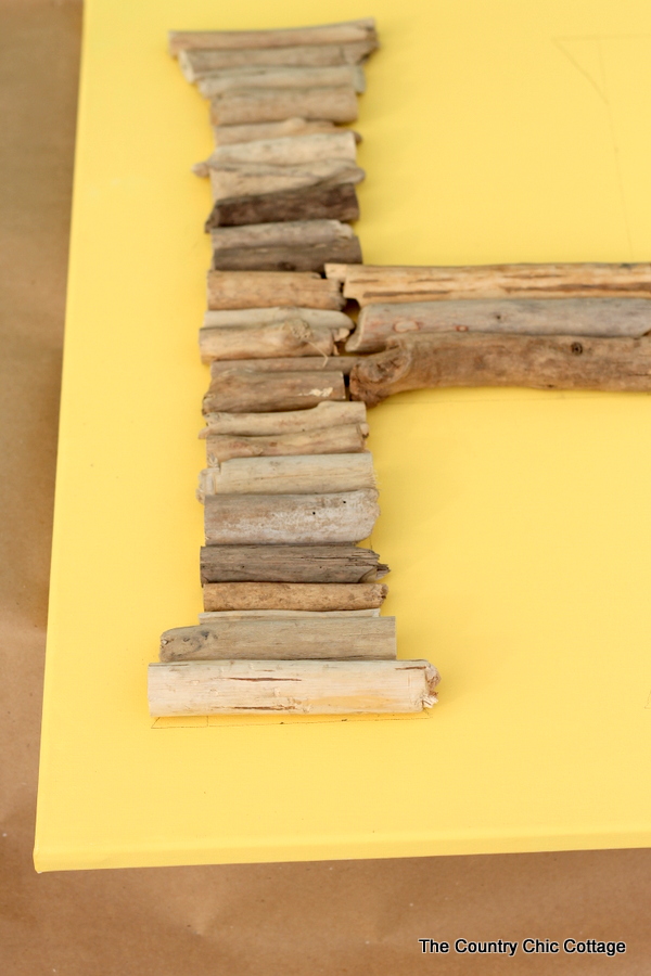 adding driftwood pieces to the monogram
