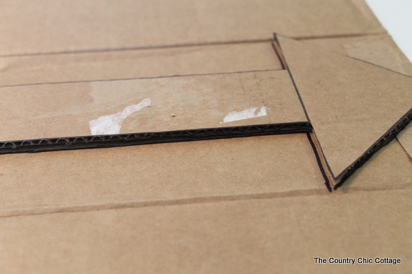 Metallic gold arrow made from cardboard boxes and Duck tape -- get the full instructions here!