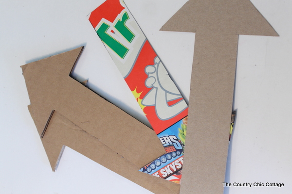 Metallic gold arrow made from cardboard boxes and Duck tape -- get the full instructions here!