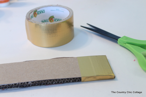 Metallic gold arrow made from cardboard boxes and Duck tape -- get the full instructions here!