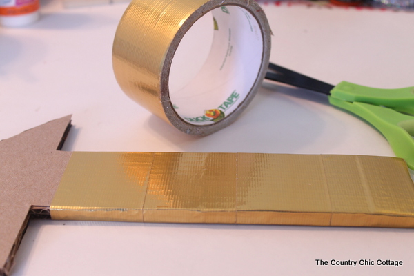 Metallic gold arrow made from cardboard boxes and Duck tape -- get the full instructions here!