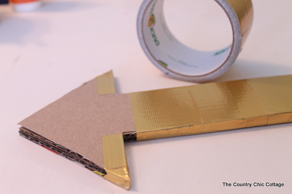 Metallic gold arrow made from cardboard boxes and Duck tape -- get the full instructions here!