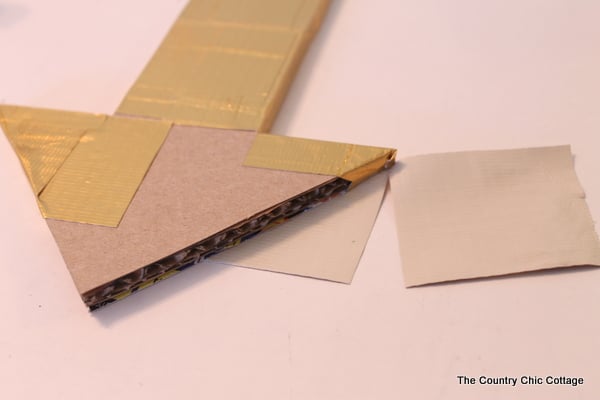 Metallic gold arrow made from cardboard boxes and Duck tape -- get the full instructions here!