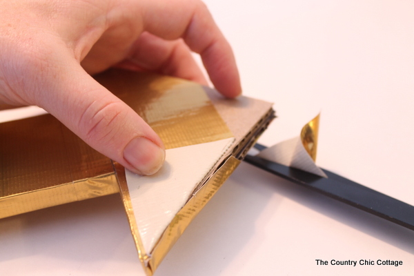 Metallic gold arrow made from cardboard boxes and Duck tape -- get the full instructions here!