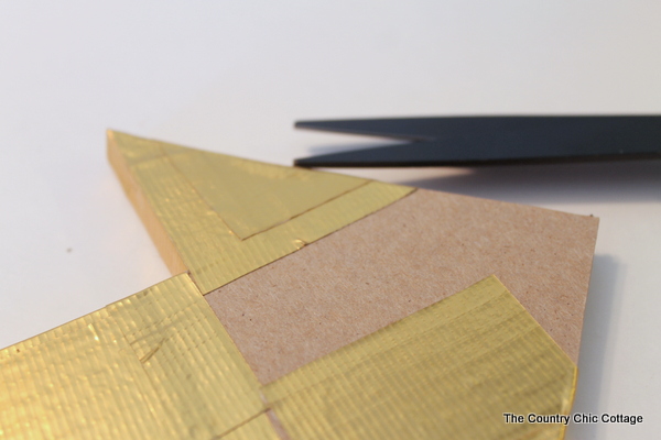 Metallic gold arrow made from cardboard boxes and Duck tape -- get the full instructions here!