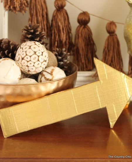 Metallic gold arrow made from cardboard boxes and Duck tape -- get the full instructions here!