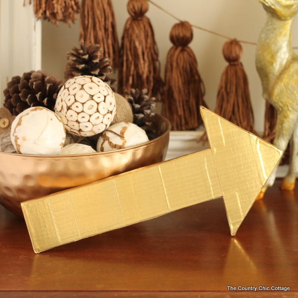 Metallic gold arrow made from cardboard boxes and Duck tape -- get the full instructions here!