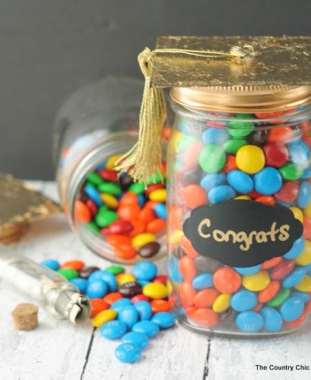 Graduation Gift in a Jar -- a fun gift for any graduate. Be sure to hide money inside of a smaller jar in the candy!