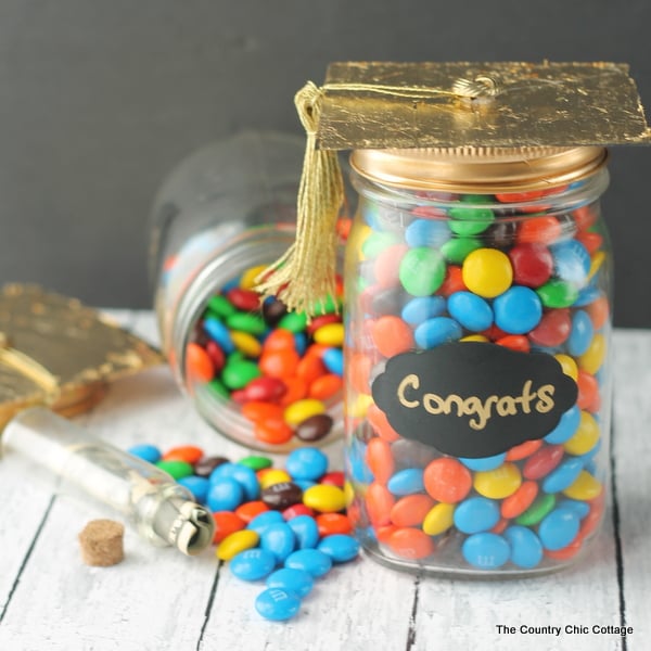 Graduation Gift in a Jar -- a fun gift for any graduate. Be sure to hide money inside of a smaller jar in the candy!