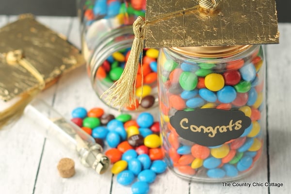 Graduation Gift in a Jar -- a fun gift for any graduate. Be sure to hide money inside of a smaller jar in the candy!