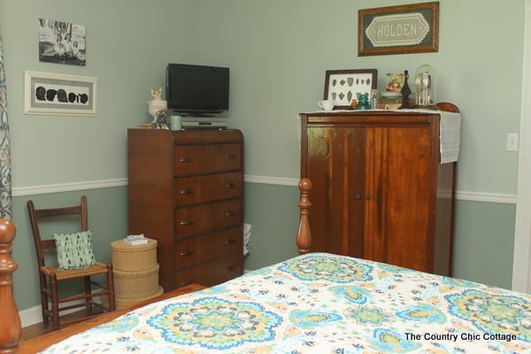 corner bedroom with a night stand, a tv and a dresser