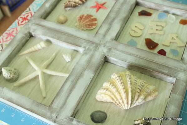 Beach Themed Shadowbox Art -- a fun nautical themed art for your home.  Add in shells and beach treasures from your vacation!