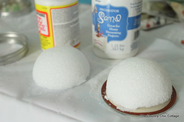 A styrofoam dome adhered to a mason jar lid with hot glue