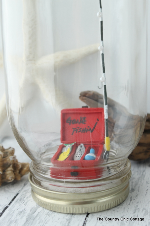 Miniature tackle box and fishing rod in a mason jar