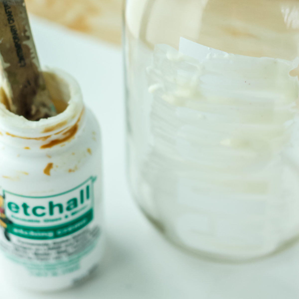 adding etching cream to mason jar