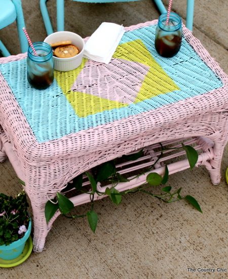 Painted Wicker Table -- add a design to wicker with spray paint with just a few supplies. Come see the step by step instructions!
