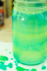 green and yellow painted mason jar