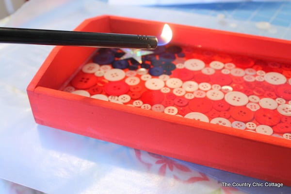 Using a lighter to get bubbles out of 4th of july tray.