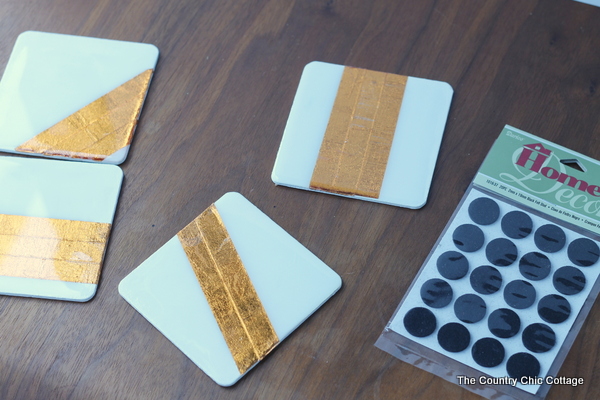 white and copper coasters with felt pads