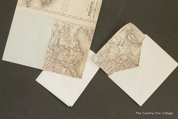 Placing the DIY envelope liners into the envelope.