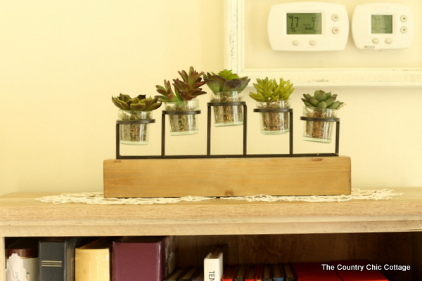 Farmhouse style bookshelf in a foyer that you really must see!  Click to get all of the details!